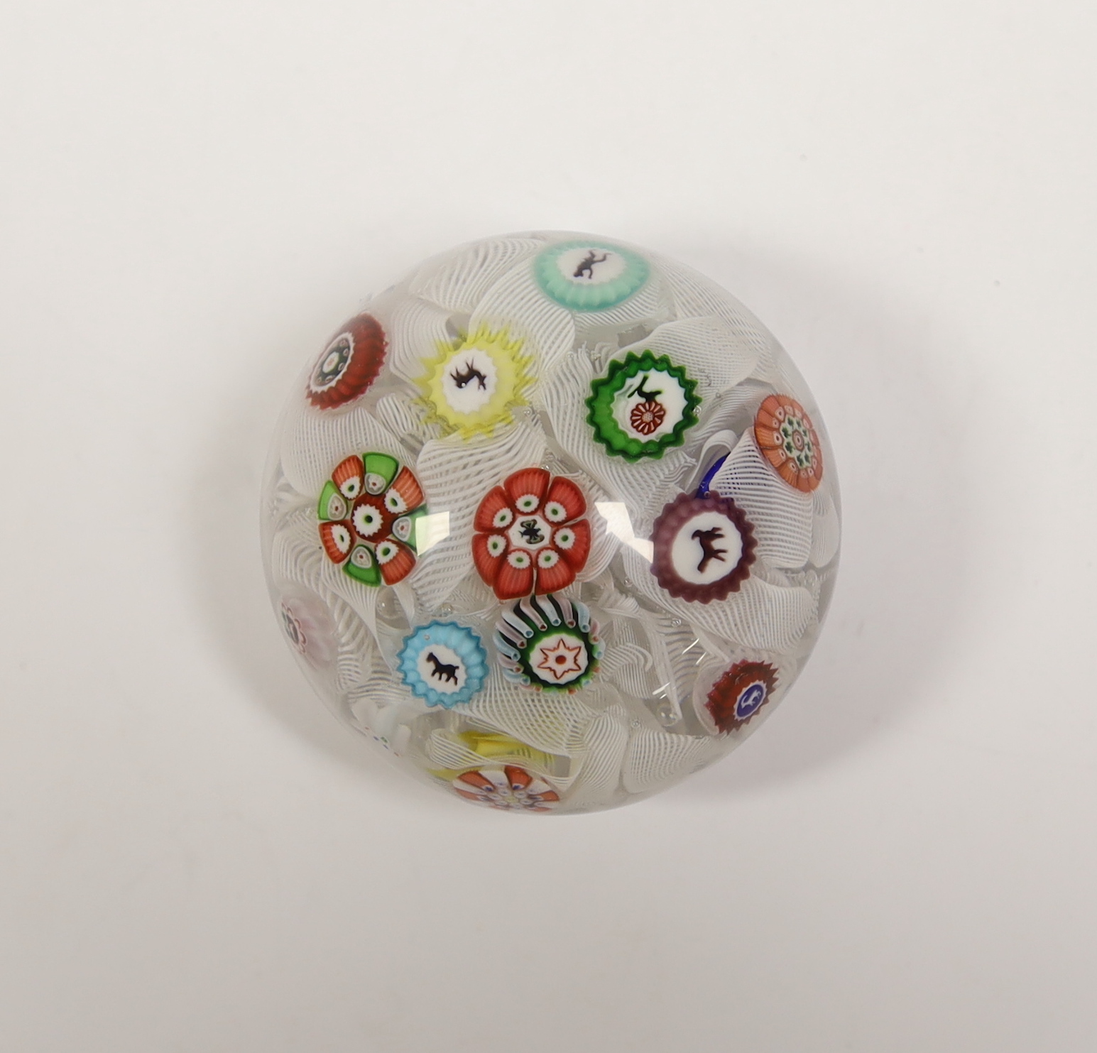 A Baccarat glass paperweight with scattered silhouette and other canes on a quilted latticino ground, dated B1848, 5.2cm